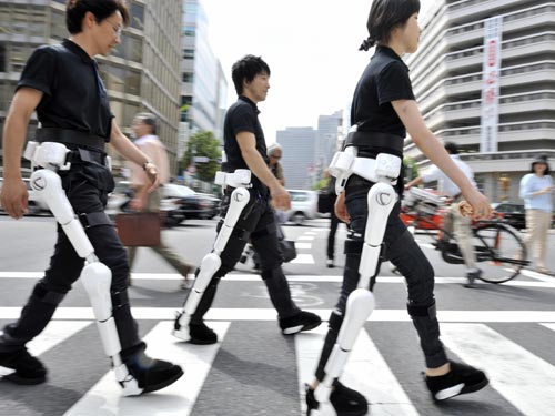 Group Demonstration of the Cyberdyne Hybrid Assistive Limb exoskeleton - Prototype Image via Very Smart Design.In this photo we witness 3 physically disabled public citizens walking with the robotic assistive legs of Cyberdyne HAL-5, wh...